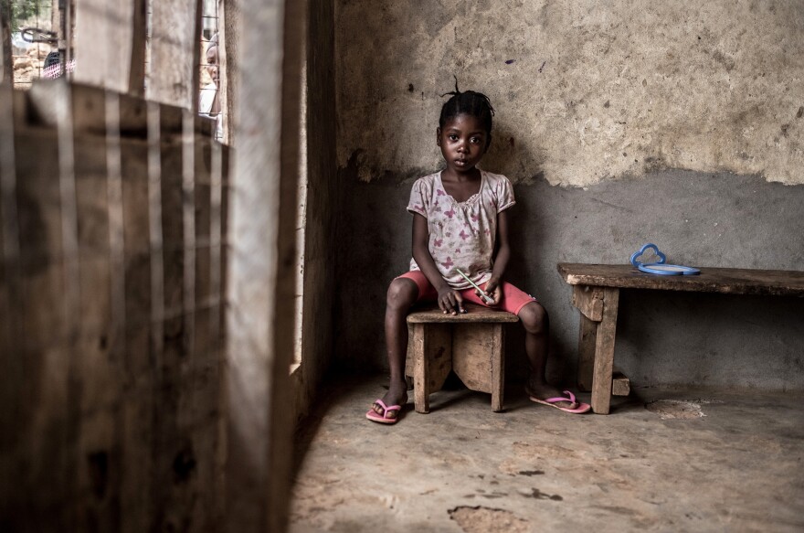 Adama, age 5, was rescued from the mudslide by her brother-in-law. Both her parents died in the disaster. She's now living in a house rented by her older sister.