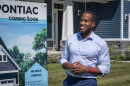 Congressman John James (R-MI 10) stands outside a newly-constructed home in Pontiac in September 2026.
