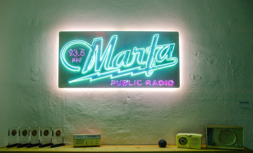 Marfa Public Radio's neon lobby logo.