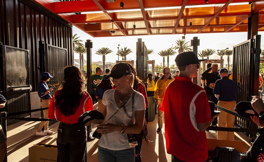 Fans enter Las Vegas Ballpark for the first time. On their way in, fans received Las Vegas Aviators souvenir baseball caps.