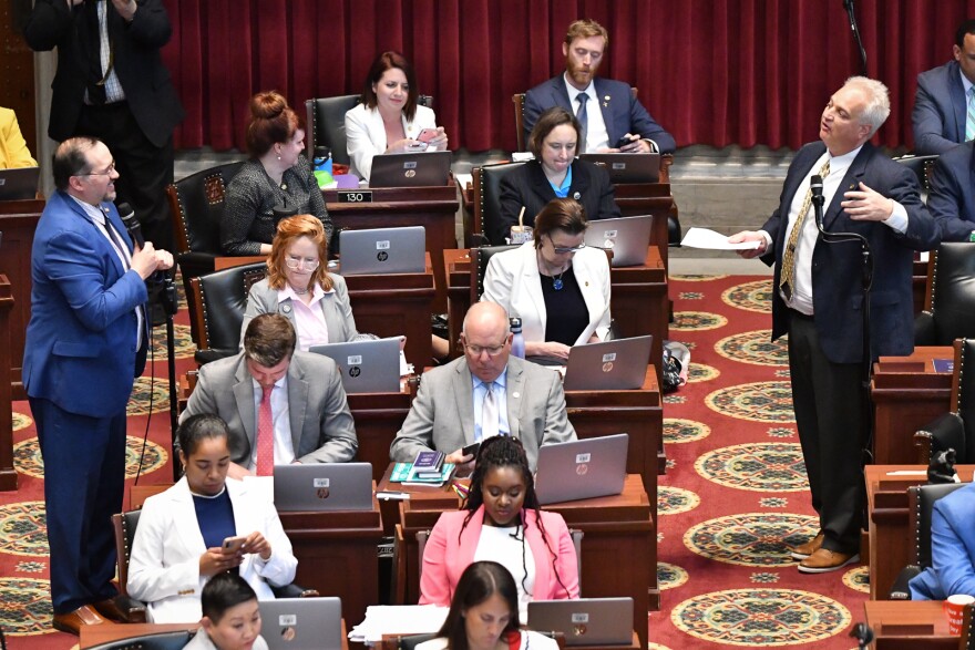 Rep. Robert Sauls (D-Independence), left, and Rep. Bruce DeGroot (R-Chesterfield) discuss Senate Bill 683 during the final hours of legislative session on Friday, May 13, 2022.
