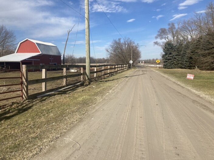 Early spring view of Ostrander homestead on the left