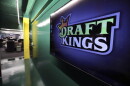Large DraftKings logo is displayed on a wall
