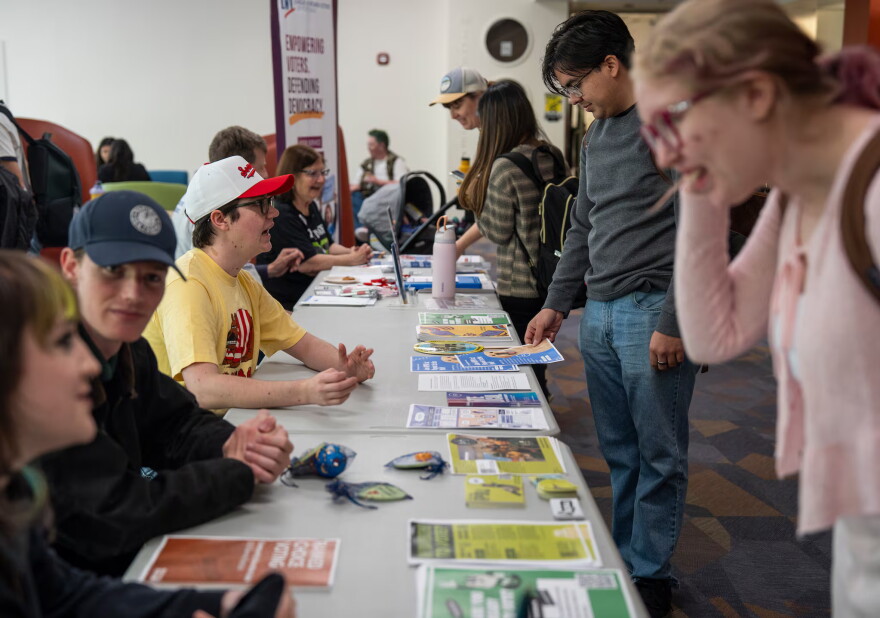 Portland State University Students and volunteers with the League of Women Voters of Portland help students at the voter registration table at Portland State University on Oct. 6, 2026.