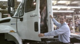 Navistar Springfield, Ohio plant manager Jim Rumpf with one of the four models of trucks now produced at the plant.