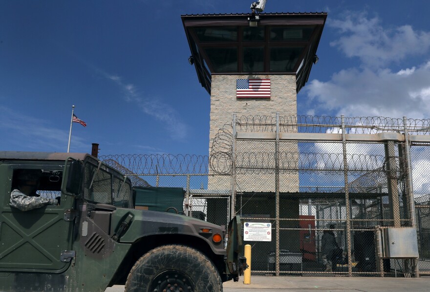 A Humvee passes the guard tower at the entrance of the U.S. prison at Guantanamo Bay in October 2016.