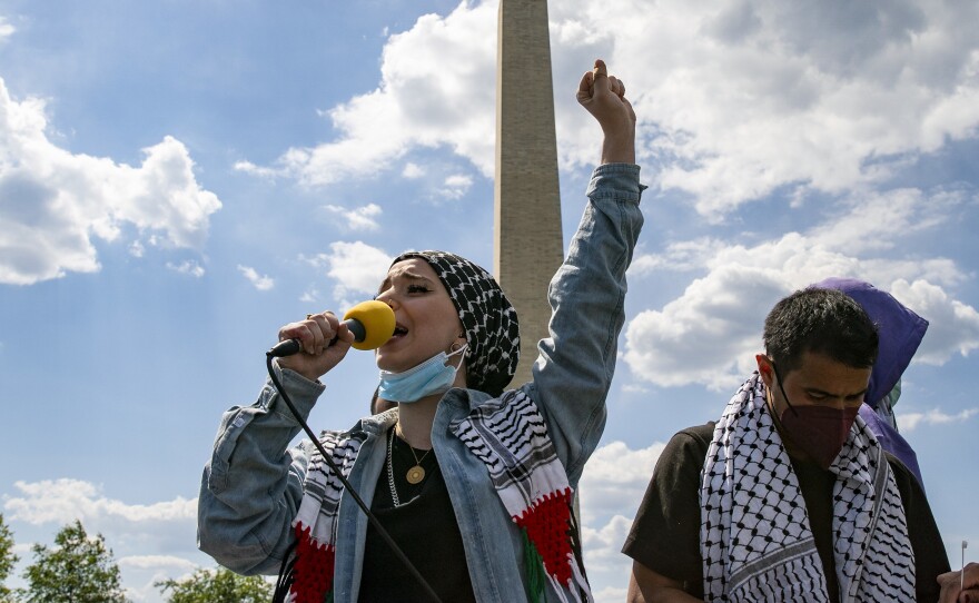 Mariam Abou-Ghazala speaks to protesters and activists near the Washington Monument as part of pro-Palestinian demonstrations around the world on Saturday.