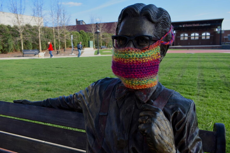 A statue of Orville Redenbacher in downtown Valparaiso with a knit mask over its face.