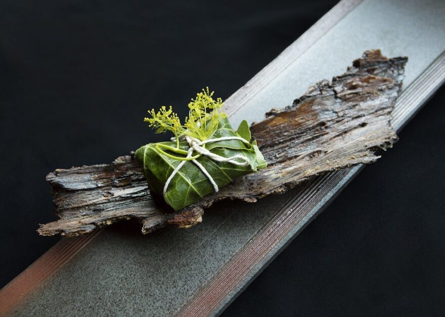 Greens served on a plate made of bark at N/Naka.