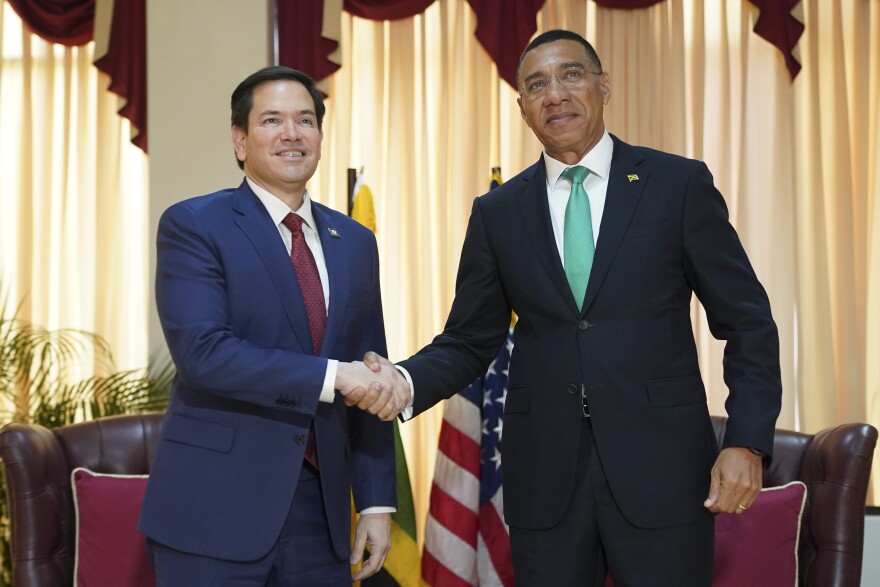 U.S. Secretary of State Marco Rubio, left, and Jamaica's Prime Minister Andrew Holness shake hands as they pose for photos