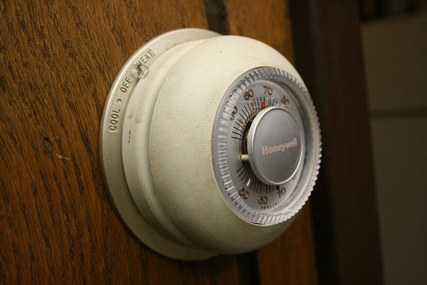 A picture of a round wall thermostat.