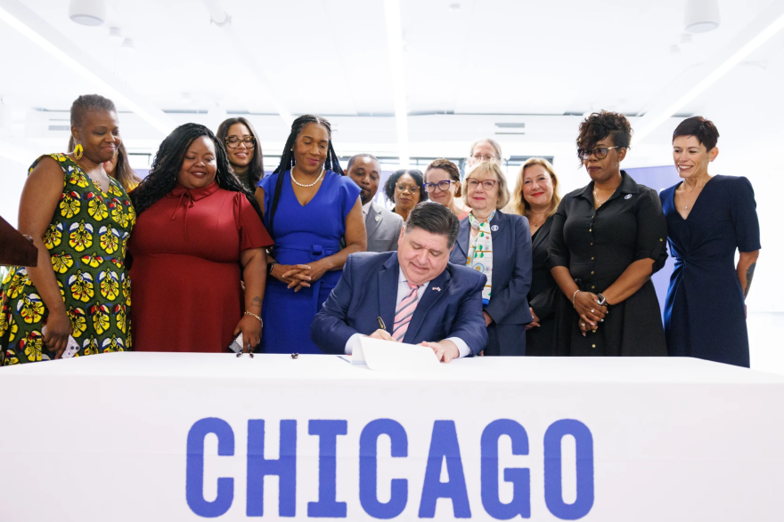 Gov. JB Pritzker signed the Birth Equity Initiative law in July 2024. To his right is Lt. Gov. Juliana Stratton, who spearheaded the law. At the time, she said that the law ensures that, as families grow, “Both mom and baby have access to care they need to get home safely.”