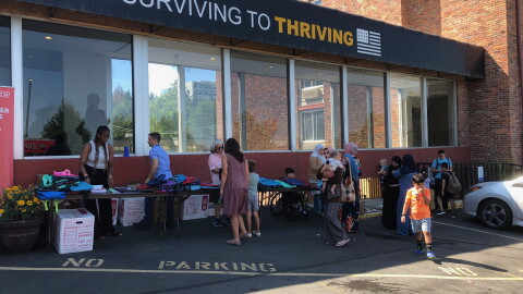 Immigrant families sort through clothes at Thrive Spokane's recent "back-to-school" celebration event.