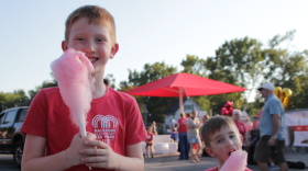 Harrison Hudson, a second grader at Hale Cook Elementary, snacks on cotton candy with his brother Henry at the school's centennial celebration.