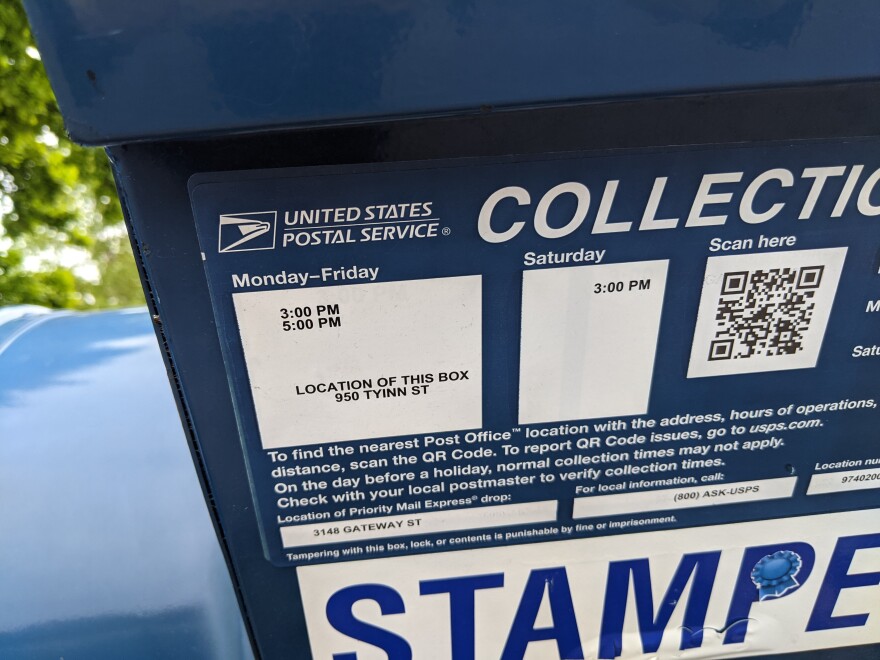 Postal mailboxes, such as this one in Eugene, list the time of day the mail is scheduled to be collected.