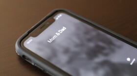 A phone ringing with Mom and Dad as the caller ID