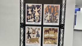 A display features four oversized Harriet Powers stamp designs.
