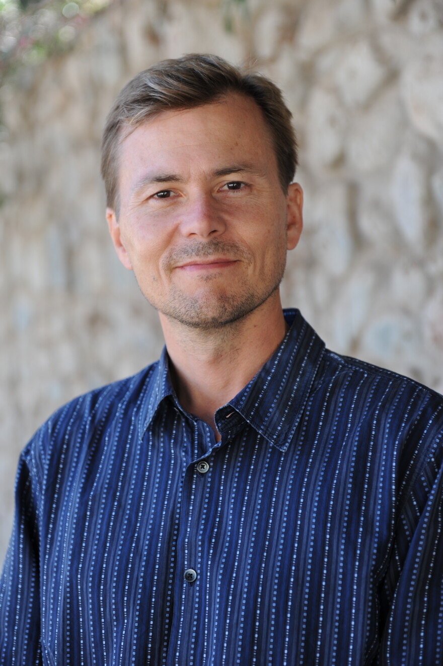 Professional portrait of a man in a blue button-down shirt