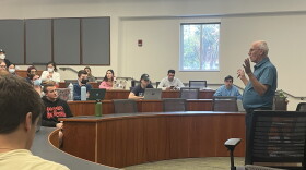 Robert Beland addresses students in a University of Florida classroom this semester. The class was preparing to give their final presentations for their marketing in hospitality and tourism graduate course. (Ashley Weinstein/WUFT News)