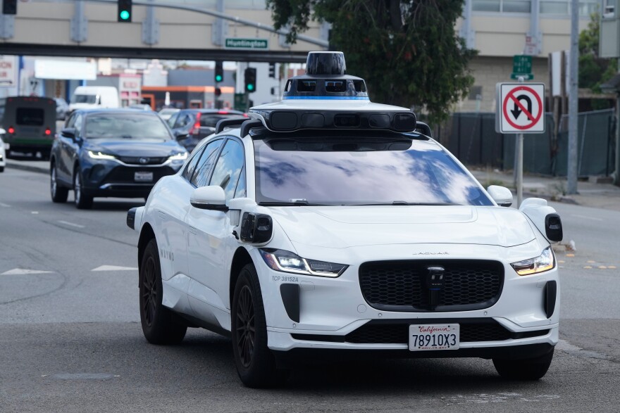 FILE - A Waymo vehicle drives past a No U-Turn sign in San Bruno, Calif., Tuesday, Sept. 30, 2025.