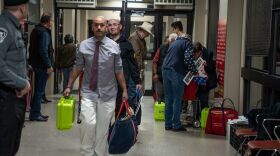 Election officials carrying equipment during last month's presidential primary in El Paso. A Texas judge says he will allow all voters to apply for absentee ballots in light of the coronavirus pandemic. The state typically makes it difficult to cast such ballots.