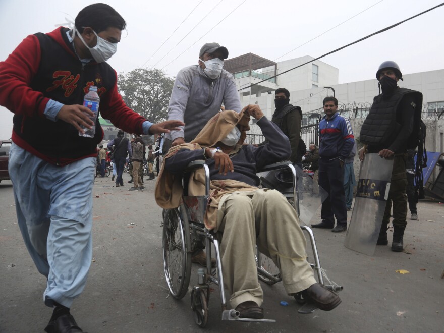 A patient is transferred after angry lawyers staged an attack on the Punjab Institute of Cardiology on Wednesday.