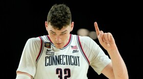 UConn center Donovan Clingan (32) celebrates after their win against Alabama in a NCAA college basketball game at the Final Four, Saturday, April 6, 2024, in Glendale, Ariz.
