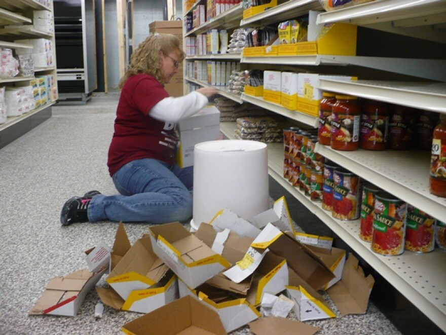 Onaga Country Market Store Manager Jane McClain gets ready for the store's opening in December. Photo by Sylvia Maria Gross/KCUR.