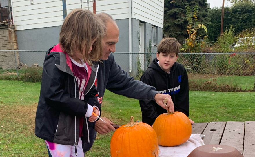 Gary Bolus carves pumpkins with his grandchildren, Will and Abby Kapmeyer.