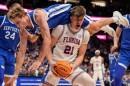 Kentucky guard Collin Chandler (5) falls onto Florida forward Alex Condon (21) during the second half of an NCAA college basketball game in the quarterfinal round of the Southeastern Conference tournament, Friday, March 13, 2026, in Nashville, Tenn. (AP Photo/George Walker IV)