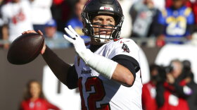 Tampa Bay Buccaneers quarterback Tom Brady (12) throws a pass against the Los Angeles Rams during the first half of the Bucs' 30-27 loss in an NFL divisional round playoff game on Jan. 23, 2022, in Tampa.