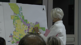 A resident places a marker on a future land-use map as she shares feedback on housing and transportation priorities during a recent planning workshop.