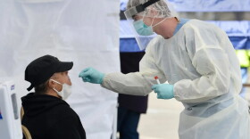 A health care worker inserts a nasal swab to test Pamela Waterman, of Hartford, for COVID-19 at Hartford HealthCare’s mobile testing site at Phillips Health Care in Hartford’s North End in May 2020.