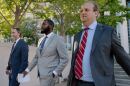 St. Louis Sheriff Alfred Montgomery, center, walks alongside his lawyers Bill Margolis, left, and Justin Gelfand after being indicted on five federal felony counts outside the Thomas F. Eagleton U.S. Courthouse on Thursday in downtown St. Louis.