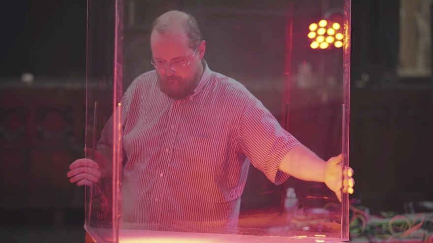 Dan Deacon positions a plexiglass case used to old rats for the <em>Rat Film </em>score.