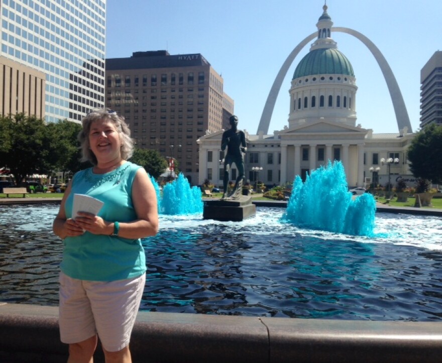 St. Louis Ovarian Cancer Awareness president Lisa Sienkiewicz stands next to the Kiener Fountain in downtown St. Louis, which has been dyed teal in honor of National Ovarian Cancer Awareness Month. 