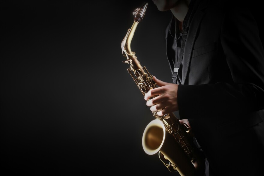 Saxophone player. Saxophonist hands playing saxophone. Alto sax player with classical music instrument closeup