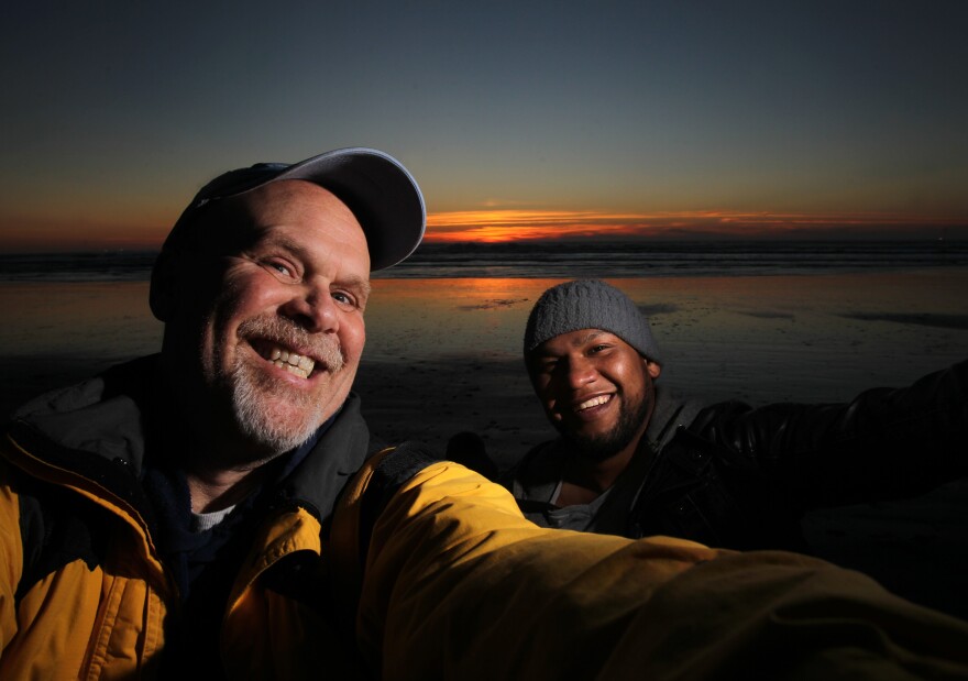 Photojournalist Tony Overman, left, poses with the late Thurston County boxer Eloy Perez at the Washington coast. 