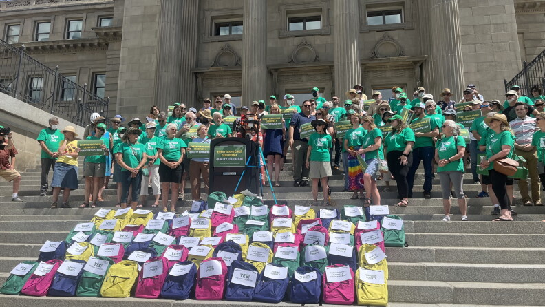 Reclaim Idaho volunteers gather outside the Idaho State Capitol, with backpacks full of signatures supporting their legislation.