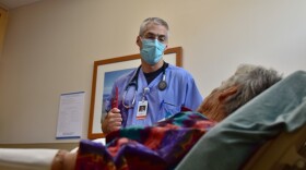 Kevin Kulow, an emergency room physician, speaks with a patient in Panama City, Florida, in April 2020.