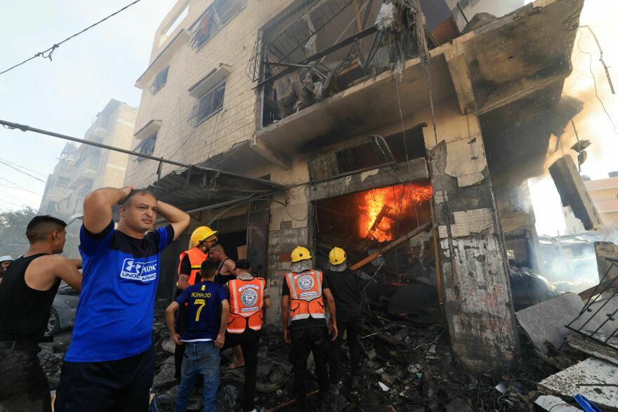 Tue., Oct. 17: Palestinian rescuers arrive at the scene after an Israeli strike in Khan Yunis in the southern Gaza Strip.