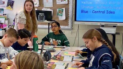 Leah Moceri (standing), a senior at Weddington High, helps a teacher at nearby Weddington Middle School as part of a pilot program to prepare for teaching jobs.