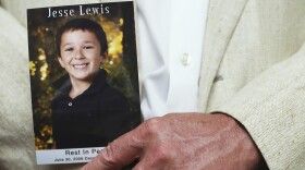 FILE: Neil Heslin holds a picture of his son Jessie Lewis, who was shot and killed during the shooting rampage at the Sandy Hook school in Newtown Conneticut., during a news conference on gun safety, on June 17, 2014 in Washington, DC. Family members of gun violence victims announced the "'Not One More' campaign urging Americans to call on Congress to pass better gun safety laws.