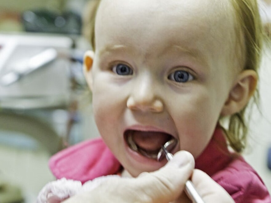 Child receiving a mouth exam