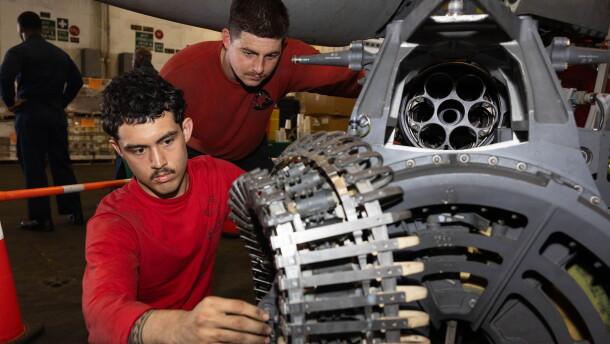 Sailors conduct maintenance on an F/A-18E Super Hornet machine gun aboard Nimitz-class aircraft carrier USS George H.W. Bush.
