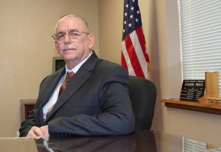 Corrections Director Robert C. Patton, seated at his desk in early 2014 shortly after taking over the department.