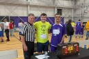 A Special Olympics coach and an athlete pose for a photo with a referee at the Special Olympics basketball tournament at Niagara University in May 2025.
