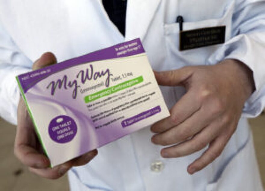 FILE - In this May 2, 2013 photo, pharmacist Simon Gorelikov holds a generic emergency contraceptive, also called the morning-after pill, at the Health First Pharmacy in Boston. (AP Photo/Elise Amendola, File)