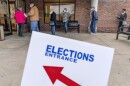 Voters line up as the doors open to the Election Center for absentee early voting for the general election in Sterling Heights, Mich., Oct. 29, 2020. 