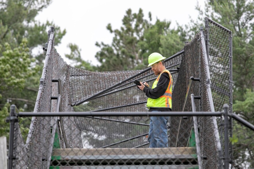 MDOT Bridge Inspector Erik Snyder inspects the pedestrian bridge over U.S. 31 at the Traverse City State Park, which was struck by an excavator towed by a truck on Thursday morning in Traverse City. Snyder said the bridge was previously scheduled for a routine inspection, but then also needed a high load hit inspection after the incident.